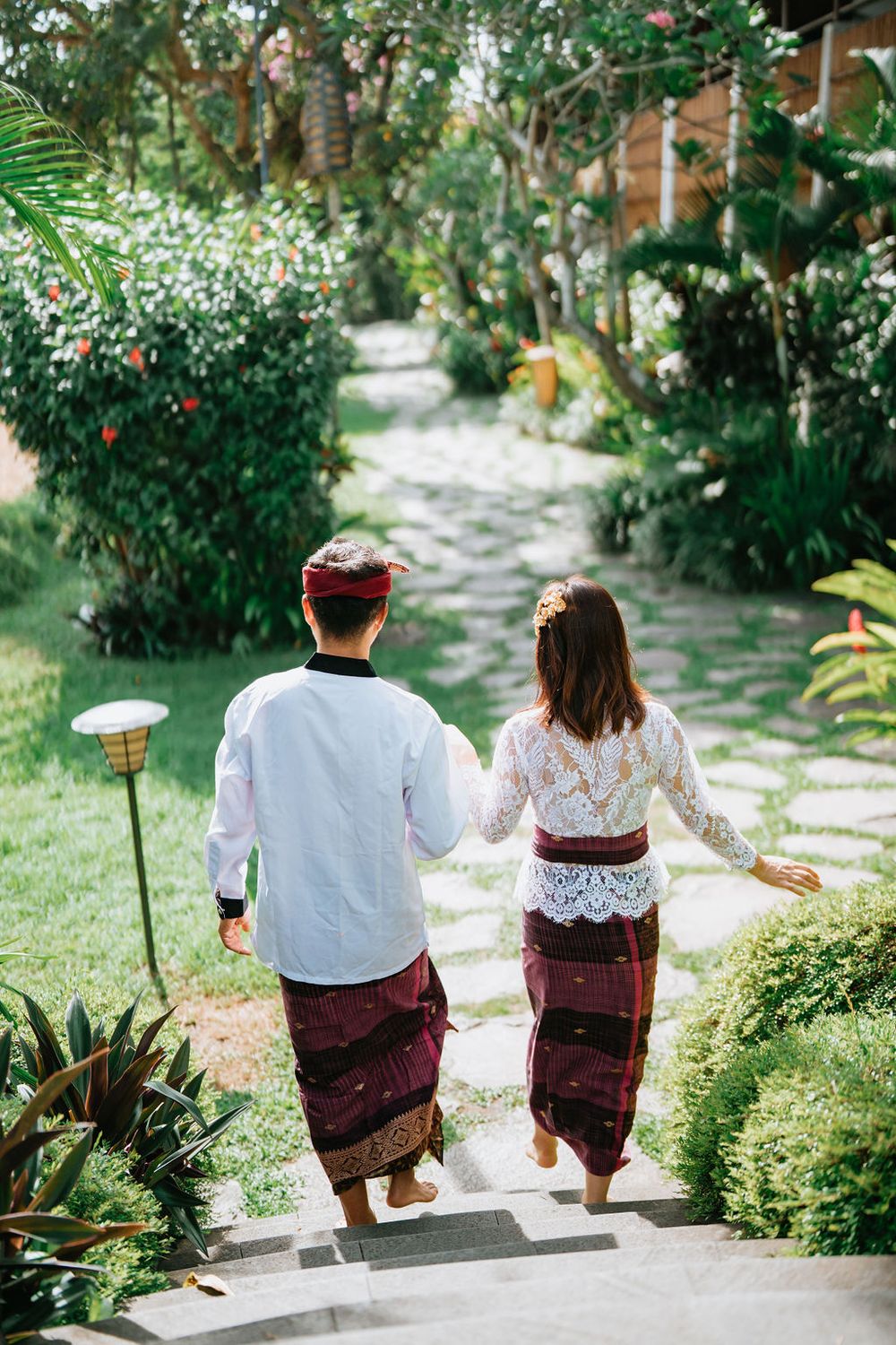 Couple wearing traditional Balinese costumes during a photoshoot at Alaya Ubud.