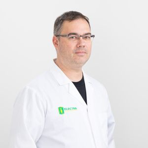 Professional headshot of engineer in white lab coat