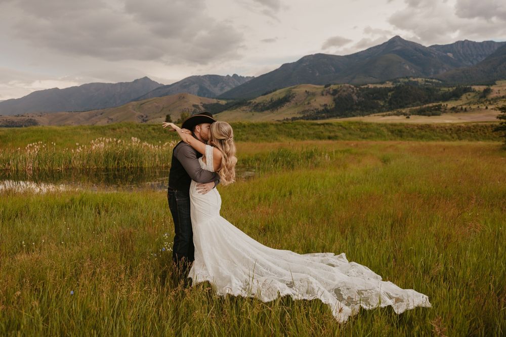 Groom kisses his bride in Paradise Valley, Montana at Copper Rose Ranch captured by local Livingston Wedding Photographer - Sabrina Marie