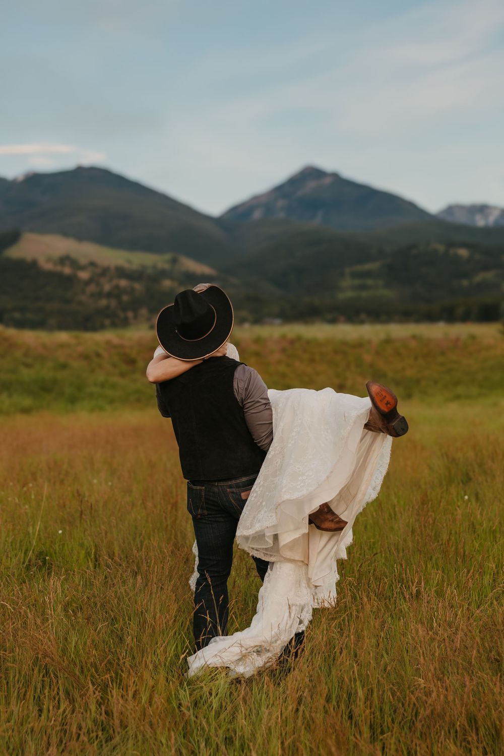 Groom kisses his bride in Paradise Valley, Montana at Copper Rose Ranch captured by local Livingston Wedding Photographer - Sabrina Marie