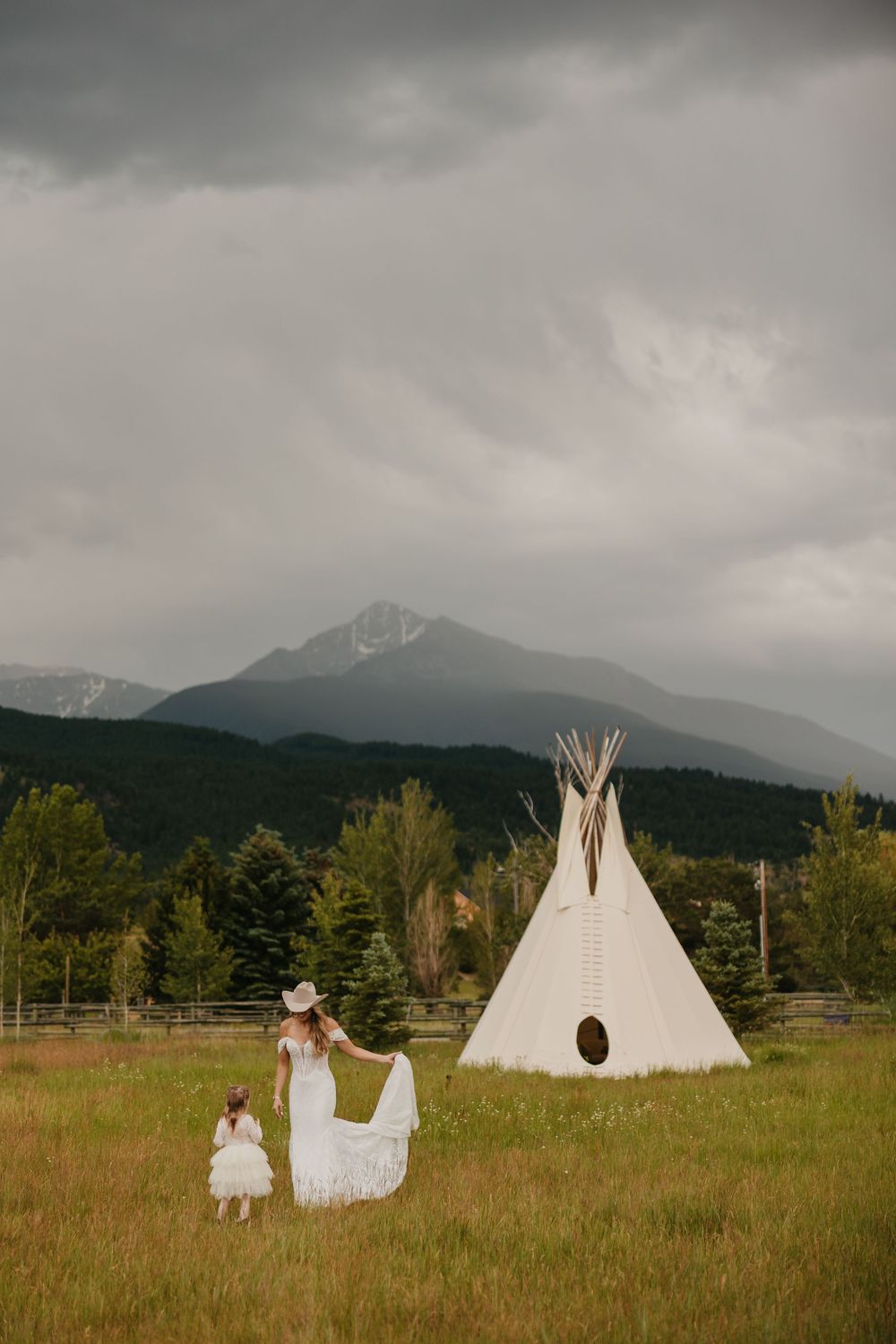 Bride dances with flower girl in front of tee-pee at Copper Rose Ranch in paradise Valley Captured by local Copper Rose Photographer