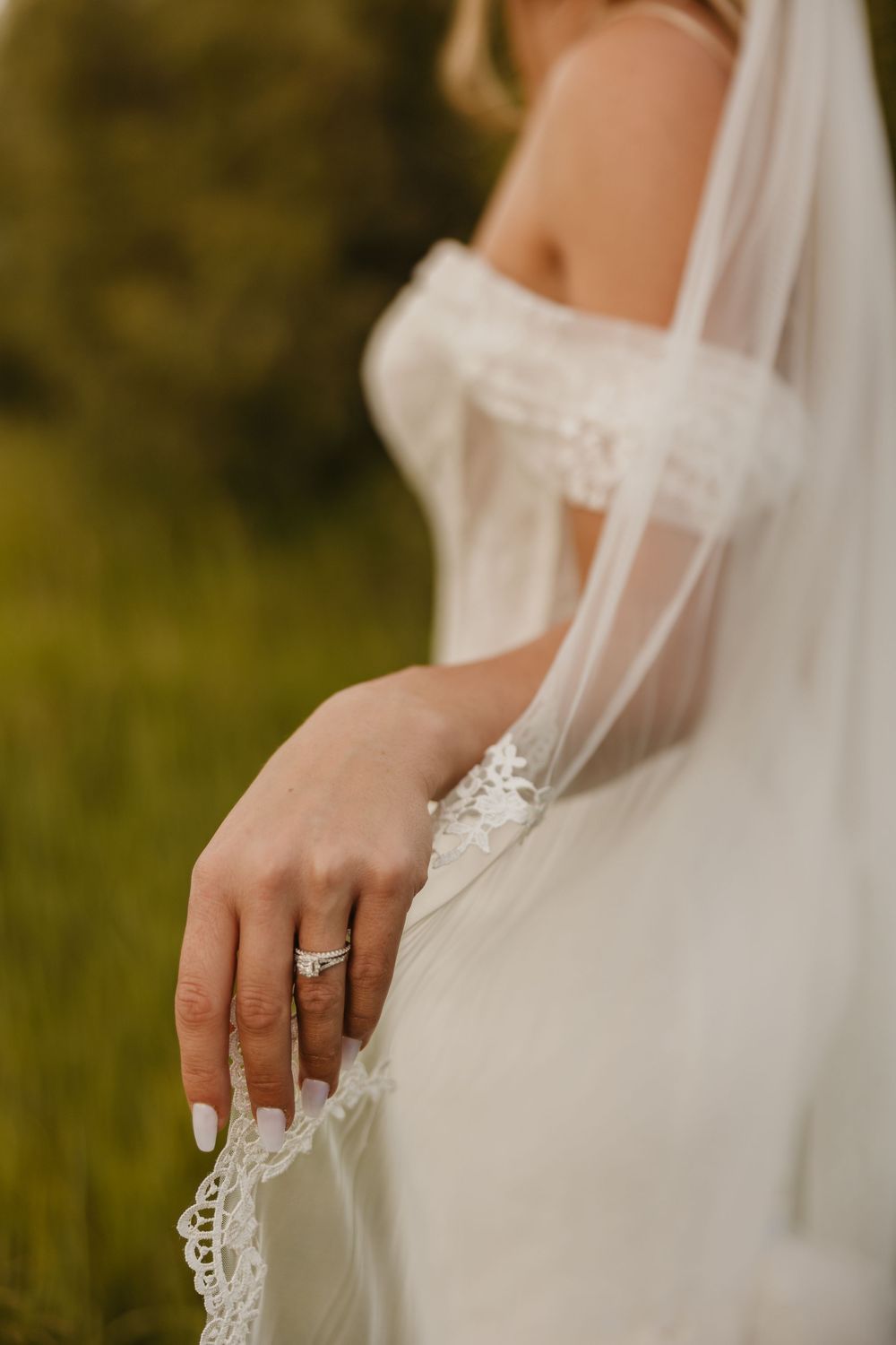 Bride shows of ring under the Mountains in Paradise Valley at Copper Rose Ranch Captured by local MT Wedding Photographer from Emigrant
