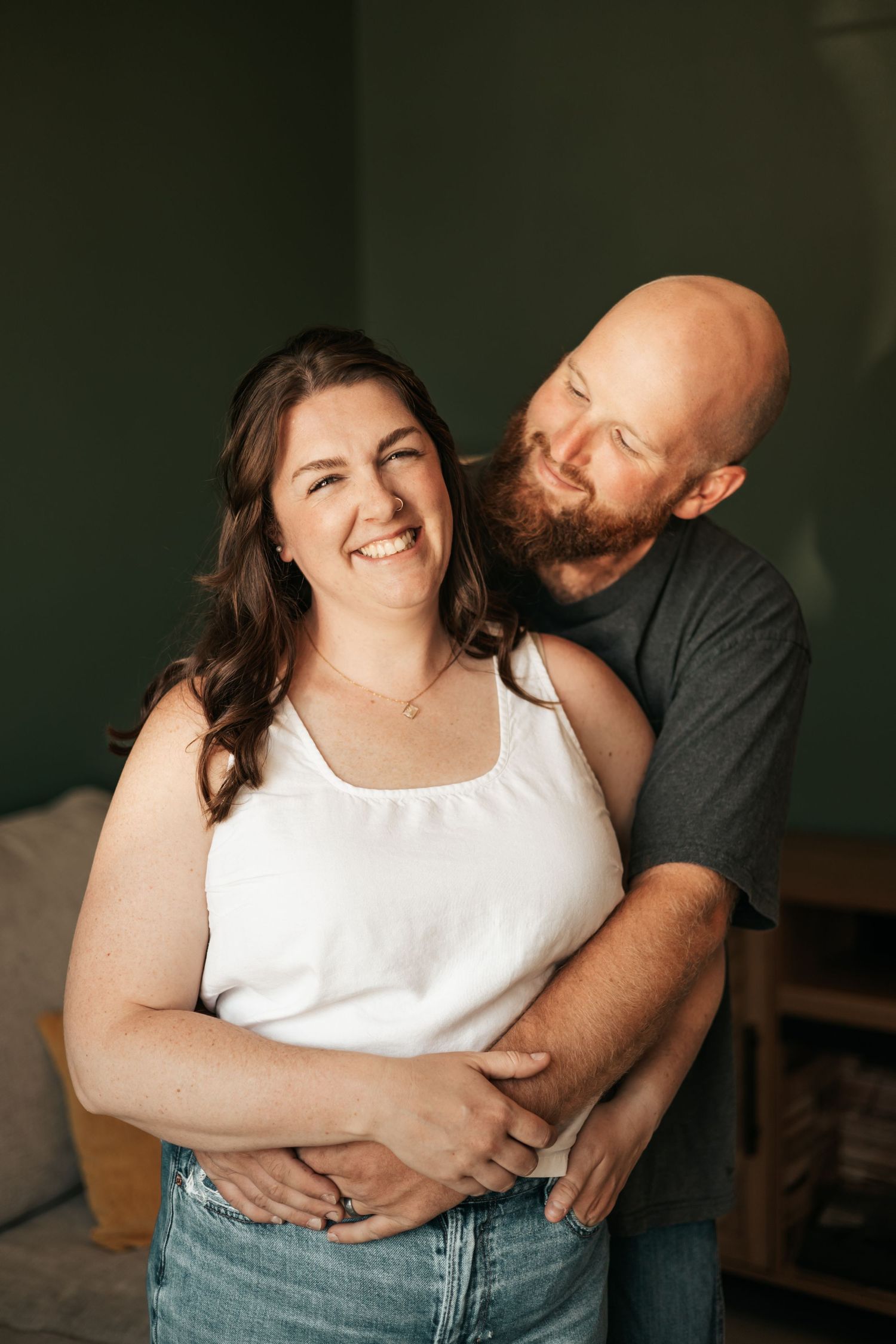 A smiling couple embraces indoors | Anniversary Photos in Johnston, Colorado