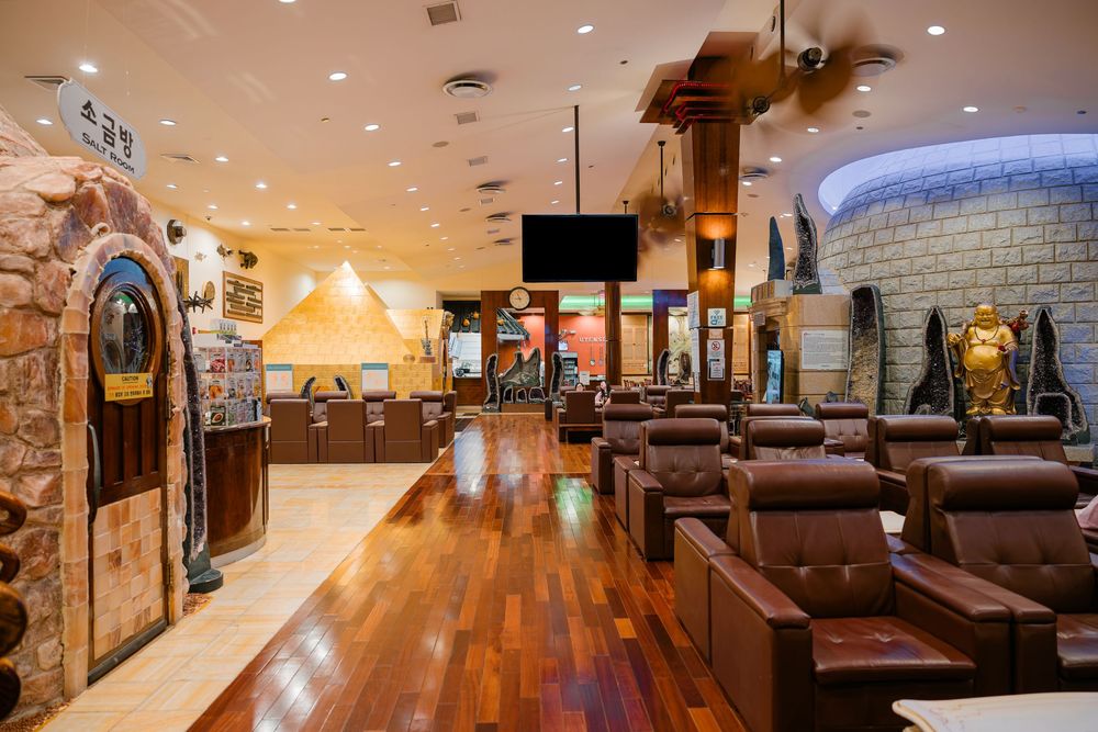 Spacious entertainment lounge with medieval castle decor, leather recliners, hardwood floors, and a flat-screen TV.