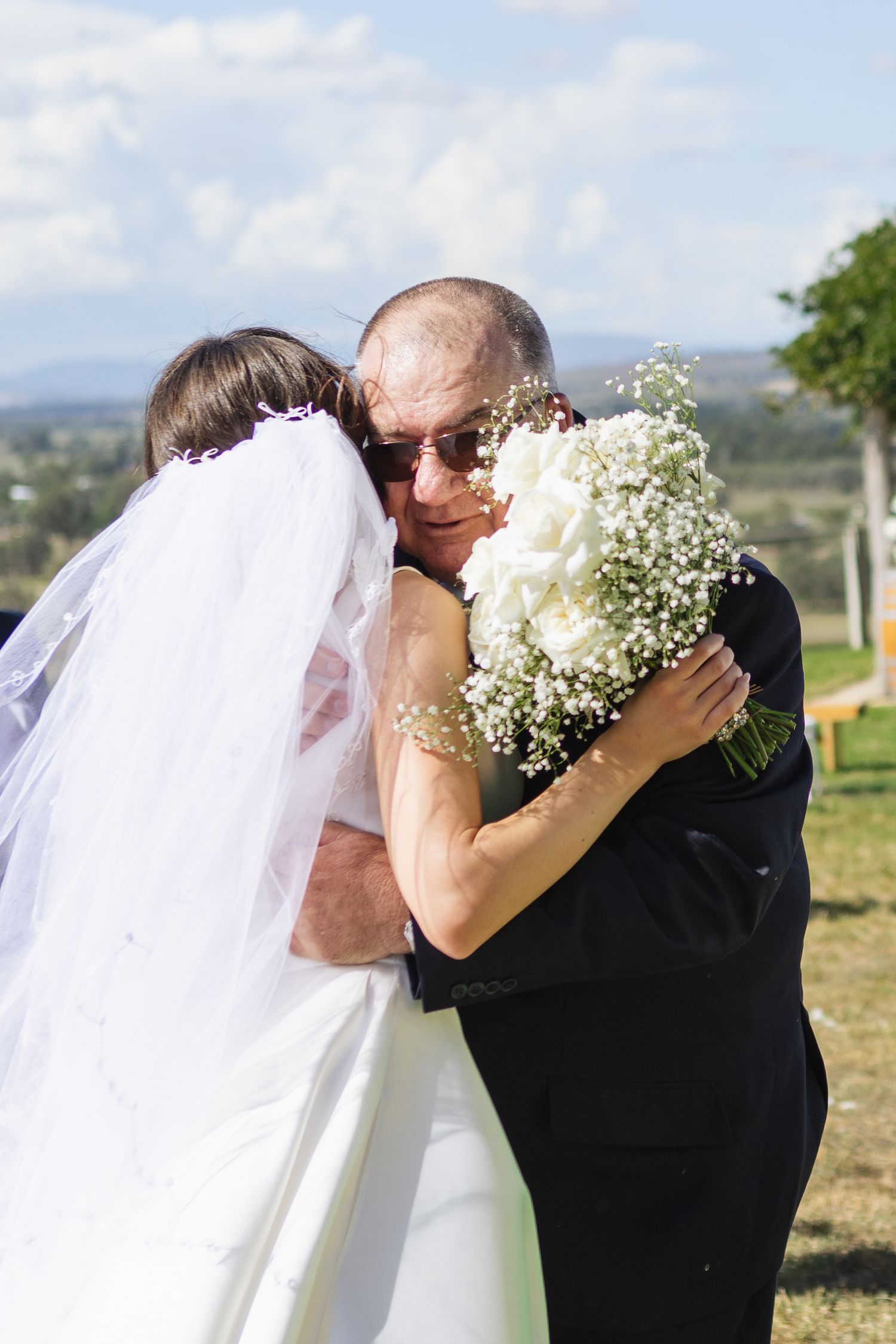 Bride and father of the bride smiling and hugging eachother at Two Rivers Winery Wedding in