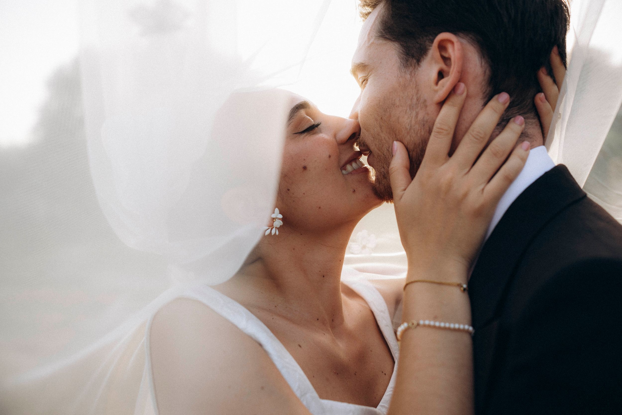 A romantic dance silhouette under stone archways with warm lighting.