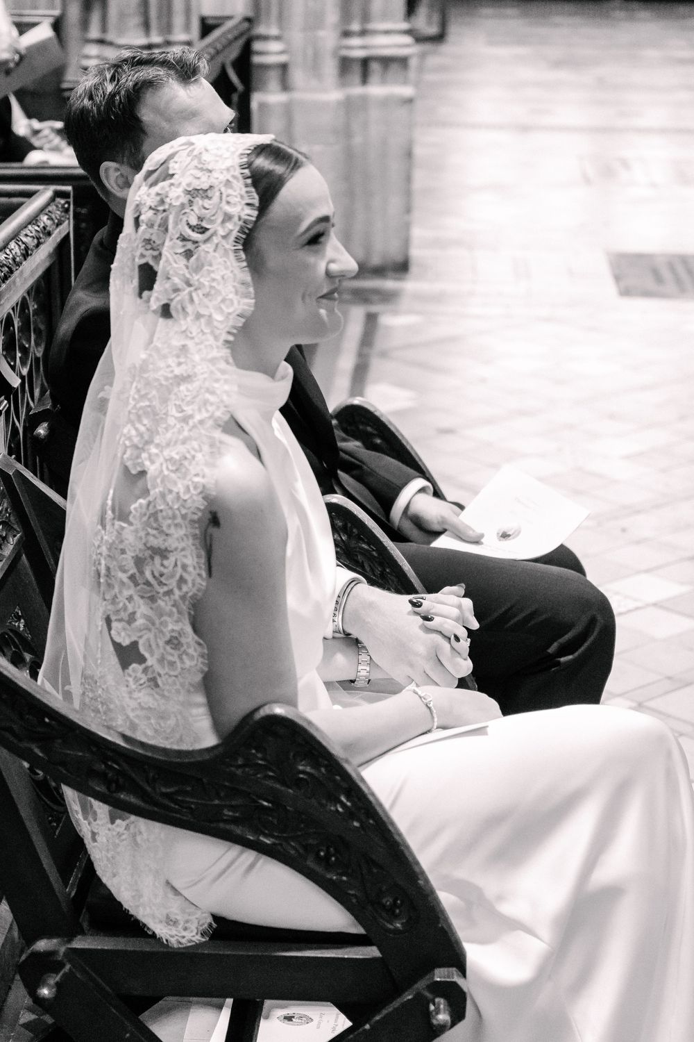 Black and white photo of a smiling bride in lace veil at St Mary Redcliffe Church, Bristol Wedding