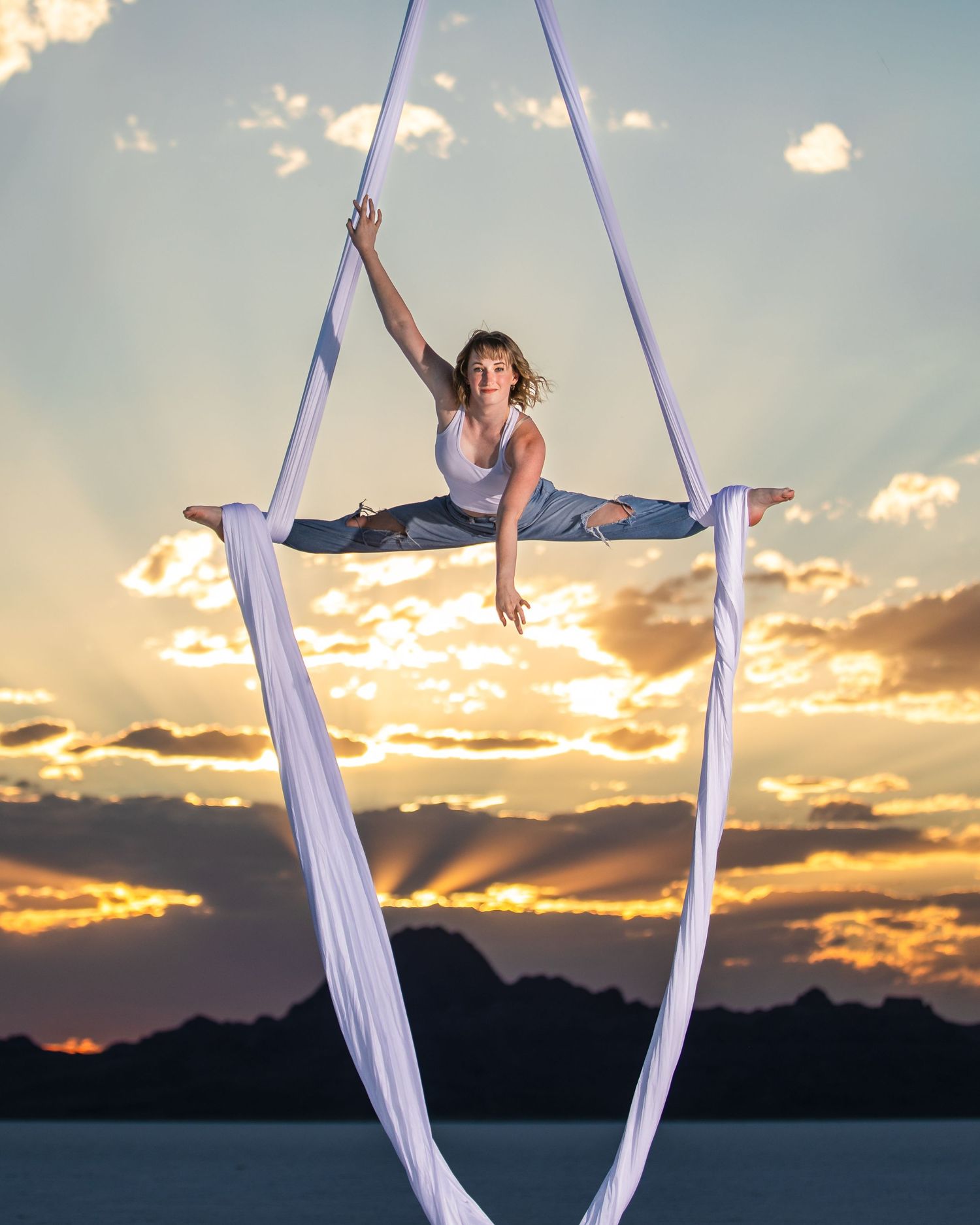 Aerialist in studio on white backdrop; professional aerial arts photography, aerial portraits, and aerialist photoshoot by expert photograph