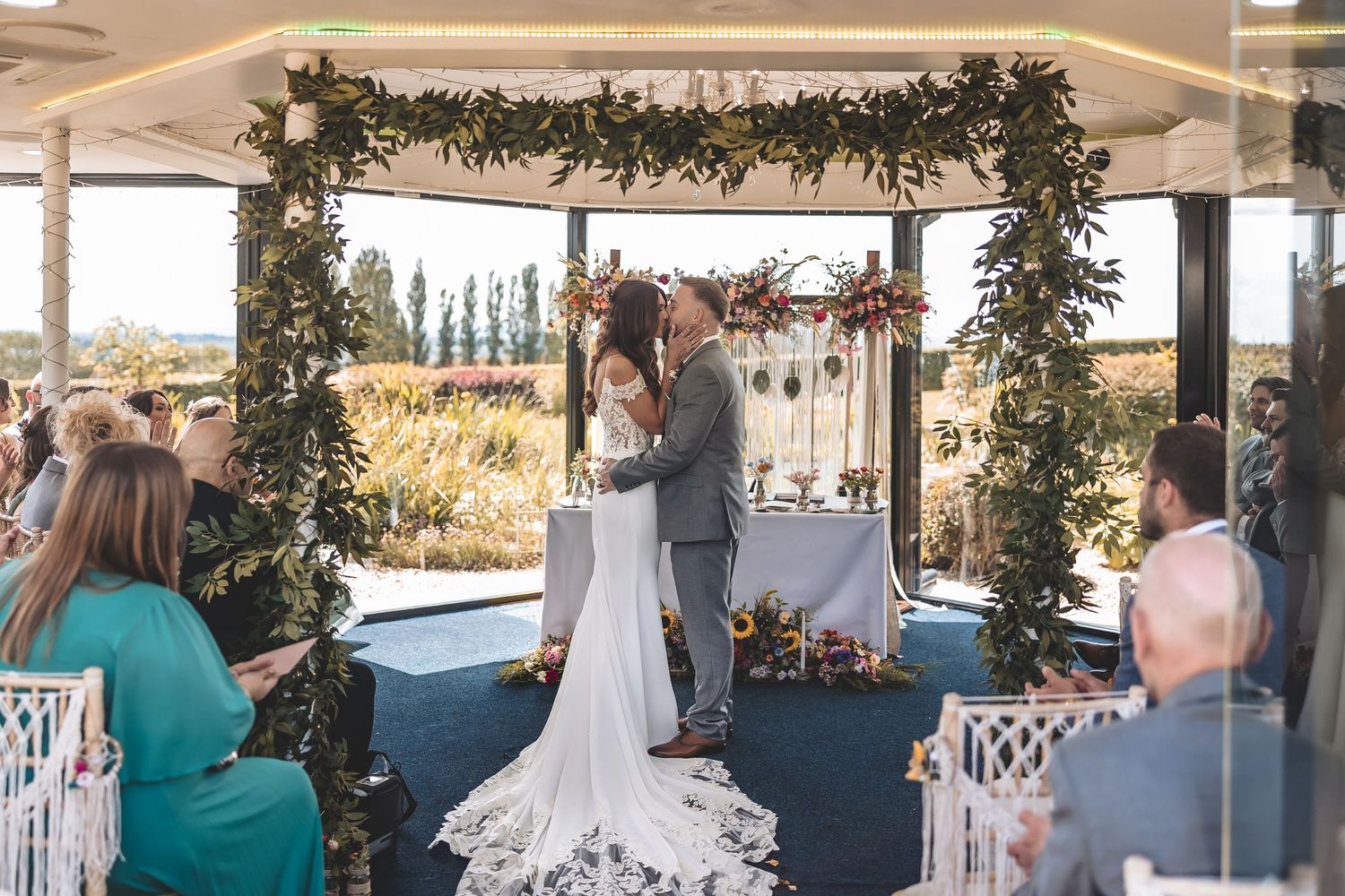 Couple sharing first kiss in their outdoor chosen ceremony area