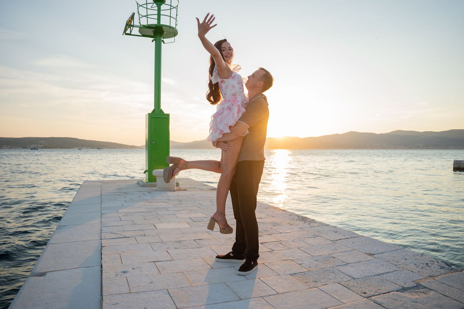 Luxury surprise proposal in Split, Croatia at sunset with romantic decorations and professional engagement photographer.