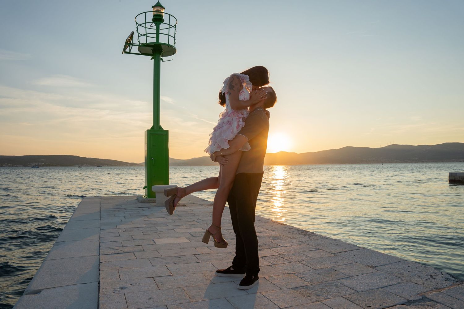 Luxury surprise proposal in Split, Croatia at sunset with romantic decorations and professional engagement photographer.