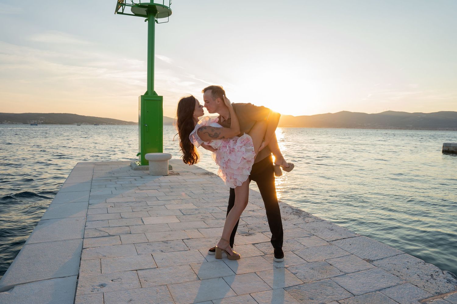 Luxury surprise proposal in Split, Croatia at sunset with romantic decorations and professional engagement photographer.