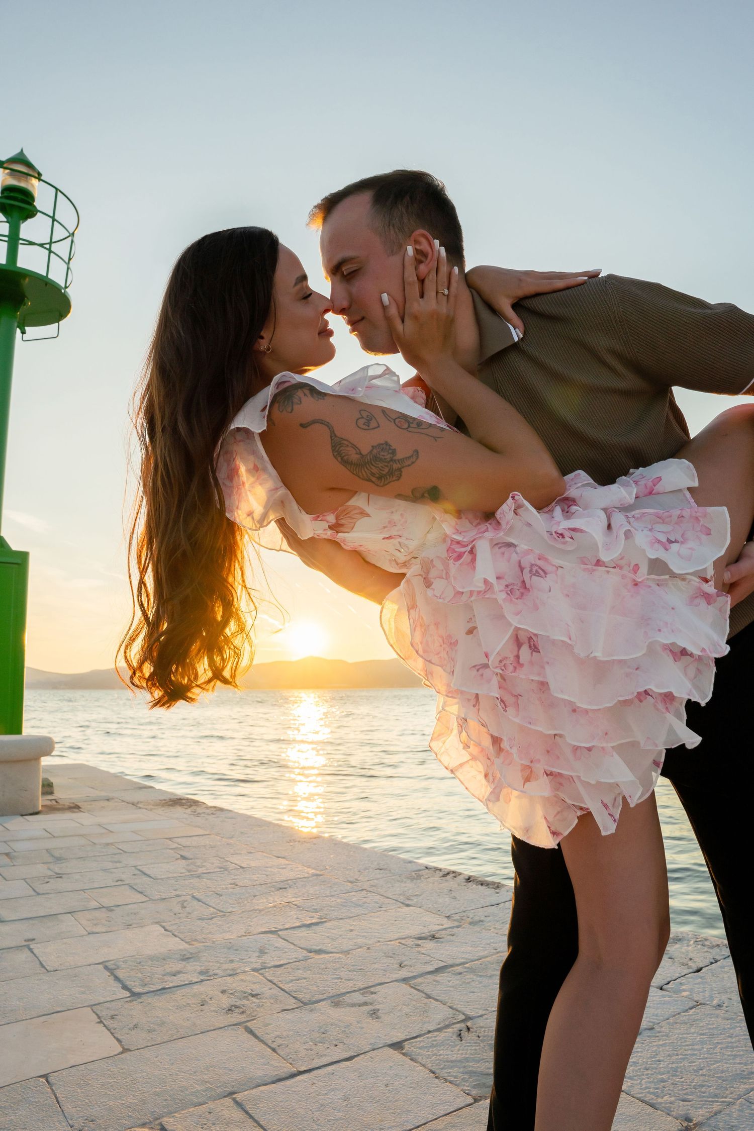Luxury surprise proposal in Split, Croatia at sunset with romantic decorations and professional engagement photographer.