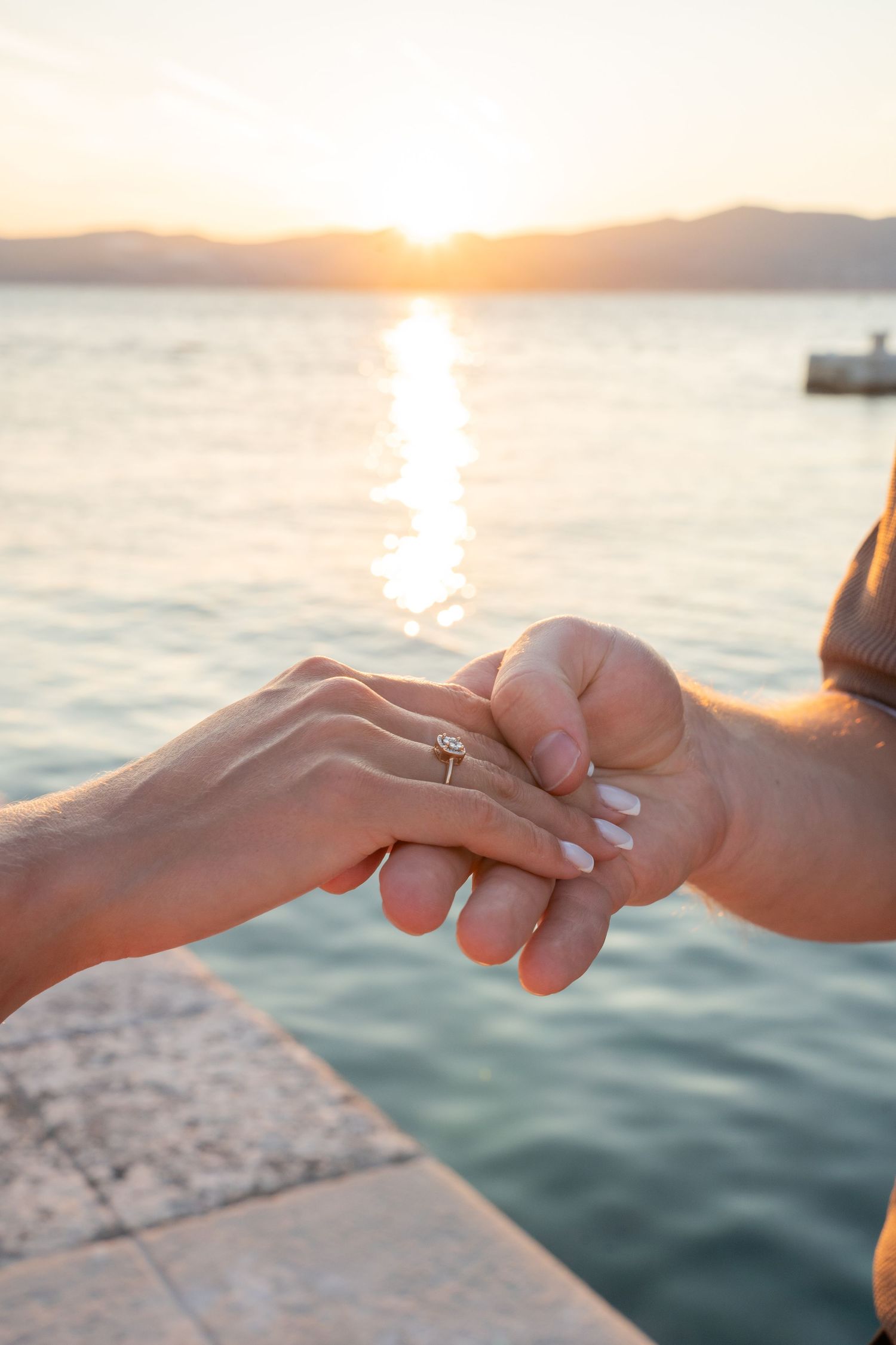Luxury surprise proposal in Split, Croatia at sunset with romantic decorations and professional engagement photographer.