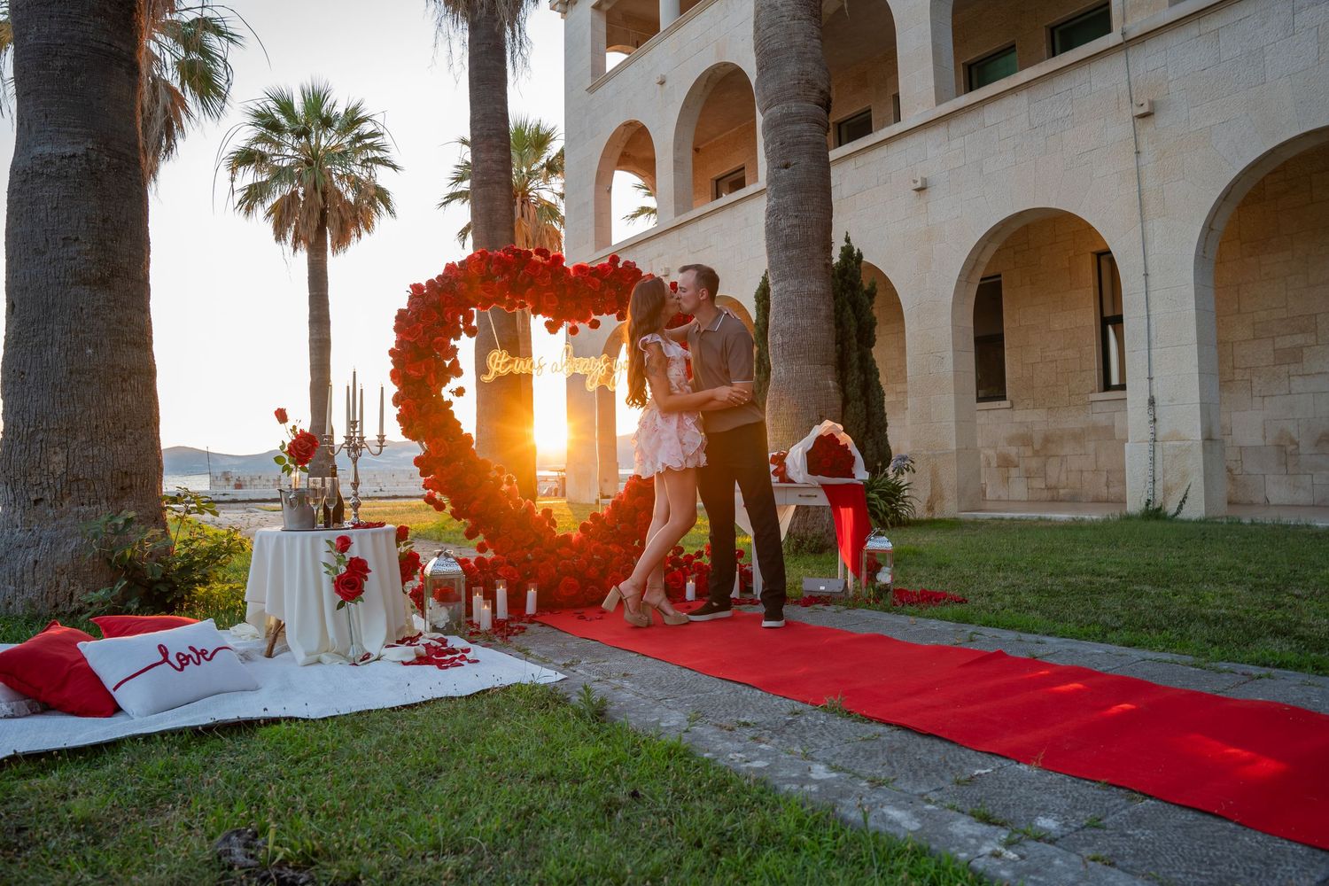 Luxury surprise proposal in Split, Croatia at sunset with romantic decorations and professional engagement photographer.