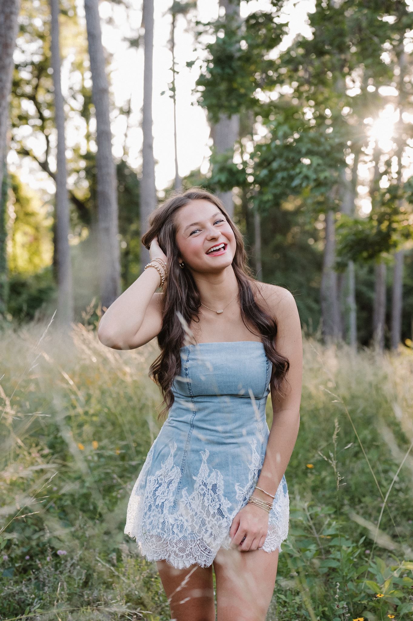 Senior girl posing in a meadow in The Woodlands Texas