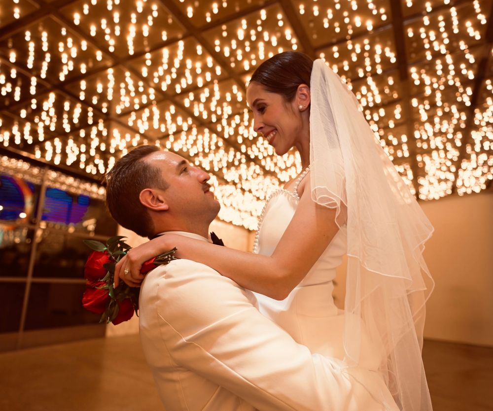 Bride and groom share a romantic moment under glittering ceiling lights at their Las Vegas wedding reception.