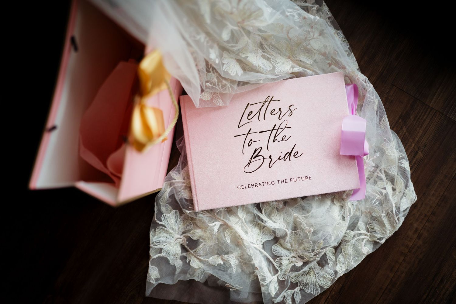 Pink 'Letters to the Bride' keepsake book celebrating the future, nestled in tissue paper inside a gift box.