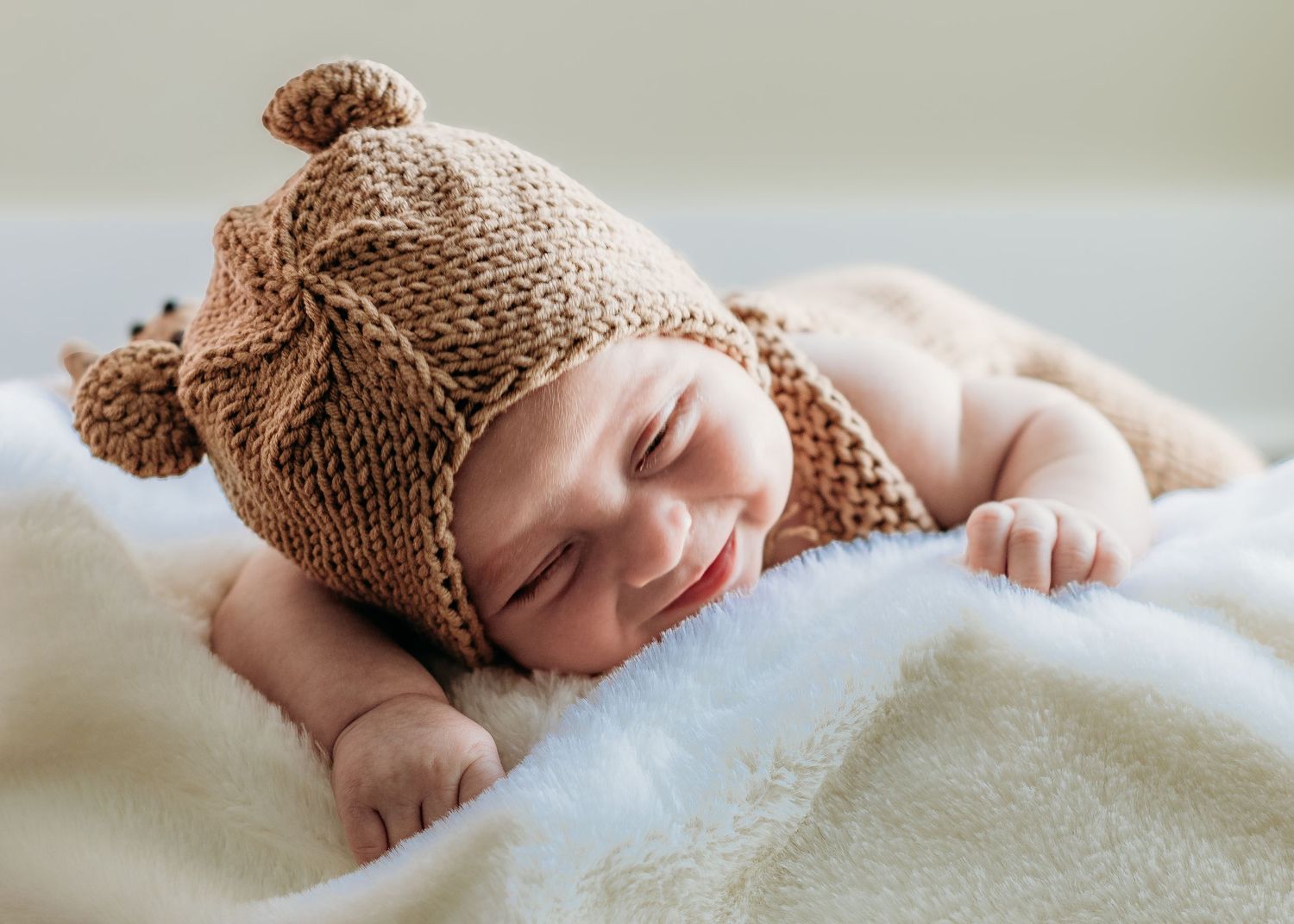 Baby boy dressed as a bear during a lifestyle newborn photography session in Deptford, NJ.