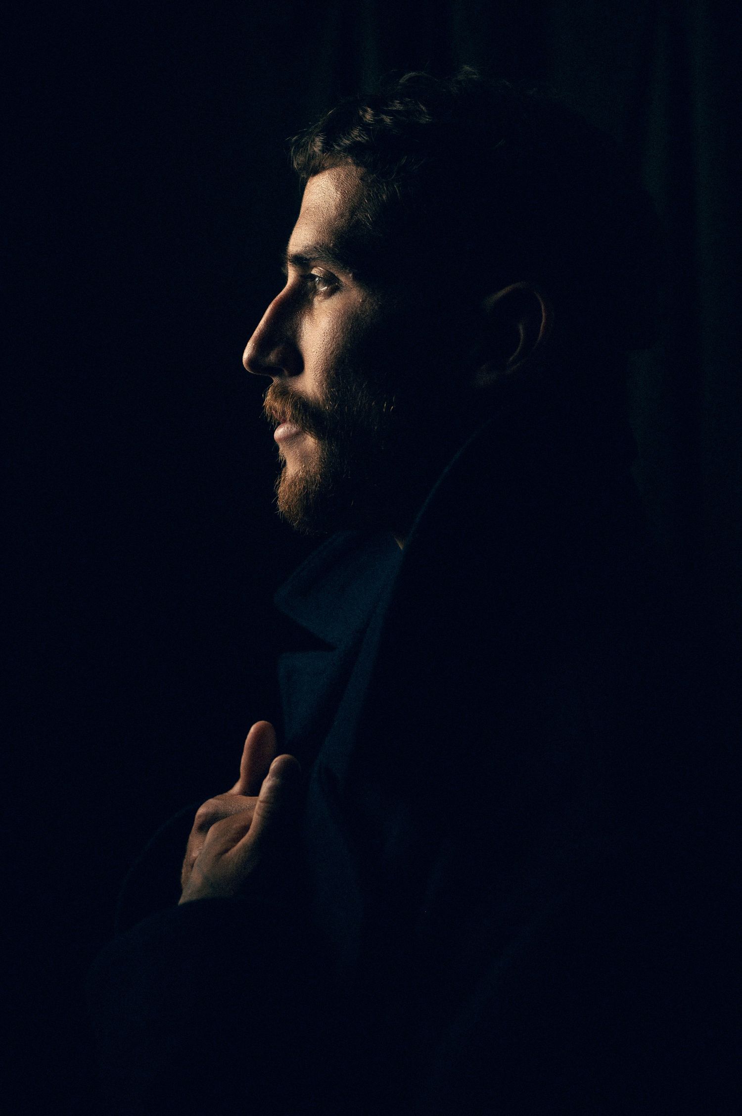 Sandy Salt Lake City Utah Male Headshot portraits by Carl James. Dramatic side profile portrait of man in dark suit against black background