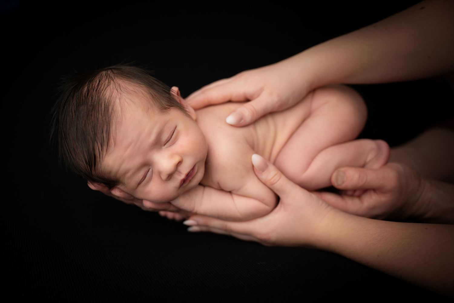 Close-up of a newborn baby posed peacefully during a studio newborn photography session in Linden, New Jersey.