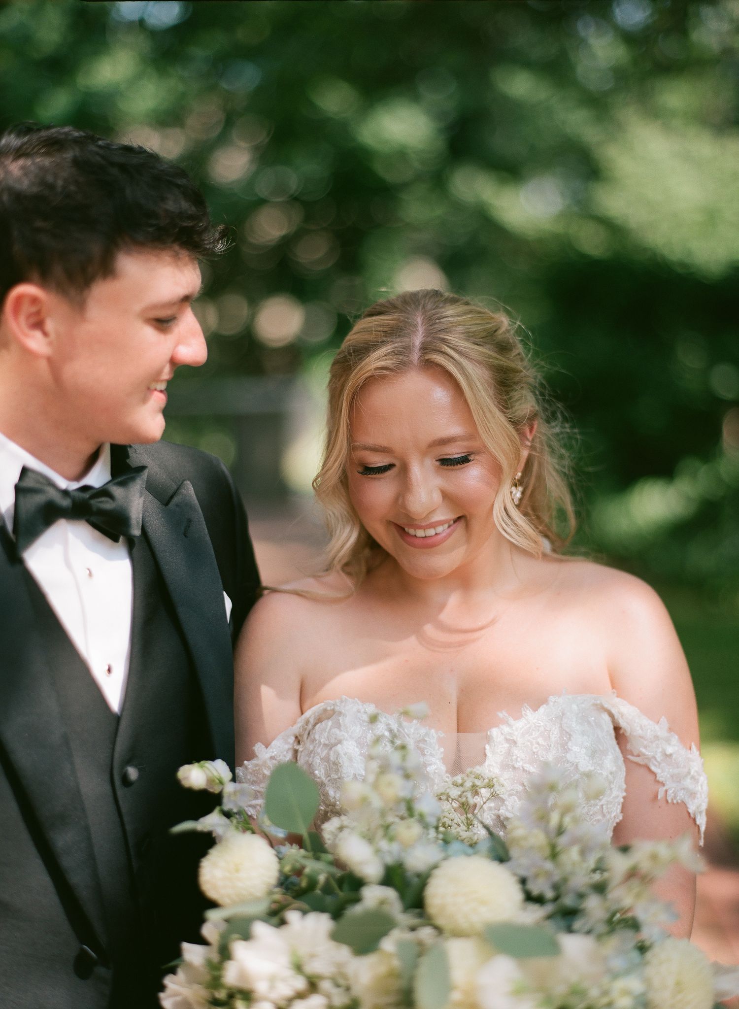A romantic close up photo of a couple about to kiss at their wedding outdoors.
