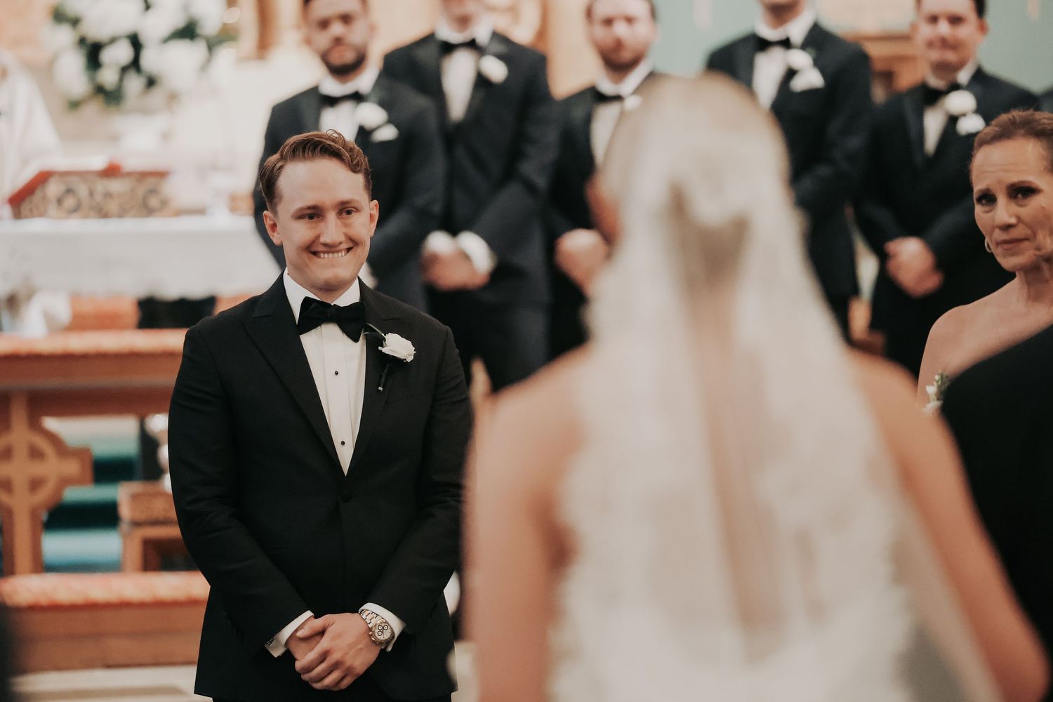 Payton waiting at the altar for Nicole during their Catholic wedding