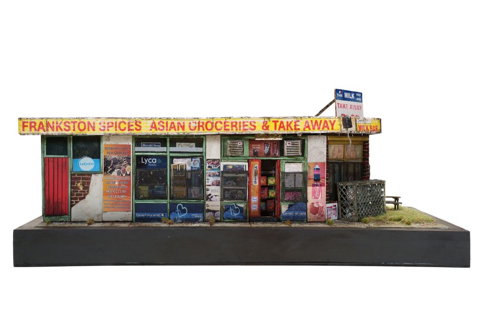 Miniature diorama model of Frankston Spices Asian Groceries and Takeaway shop facade with colorful signage.