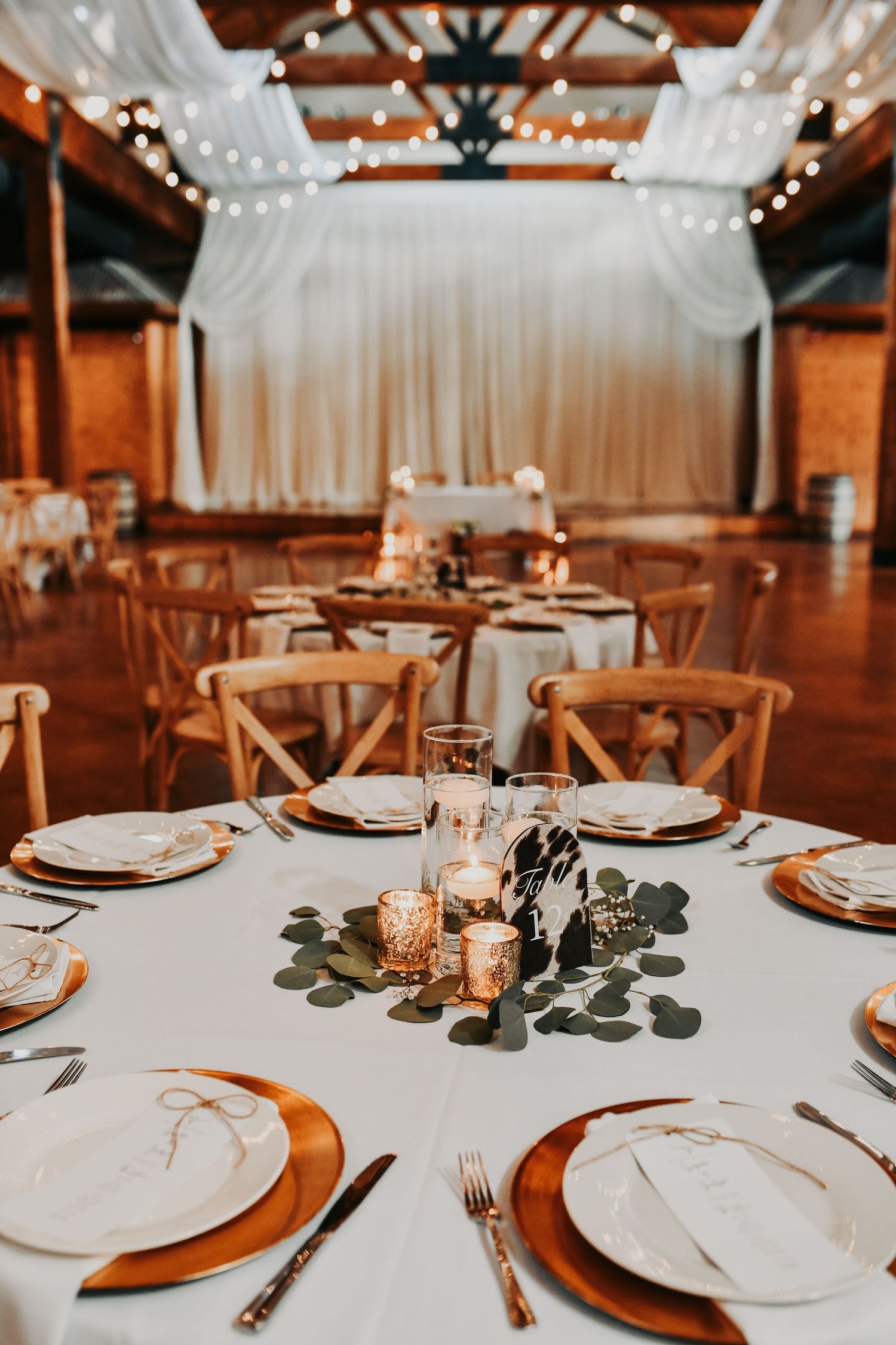 Romantic Lucky Spur Ranch wedding reception details with greenery and gold decor
