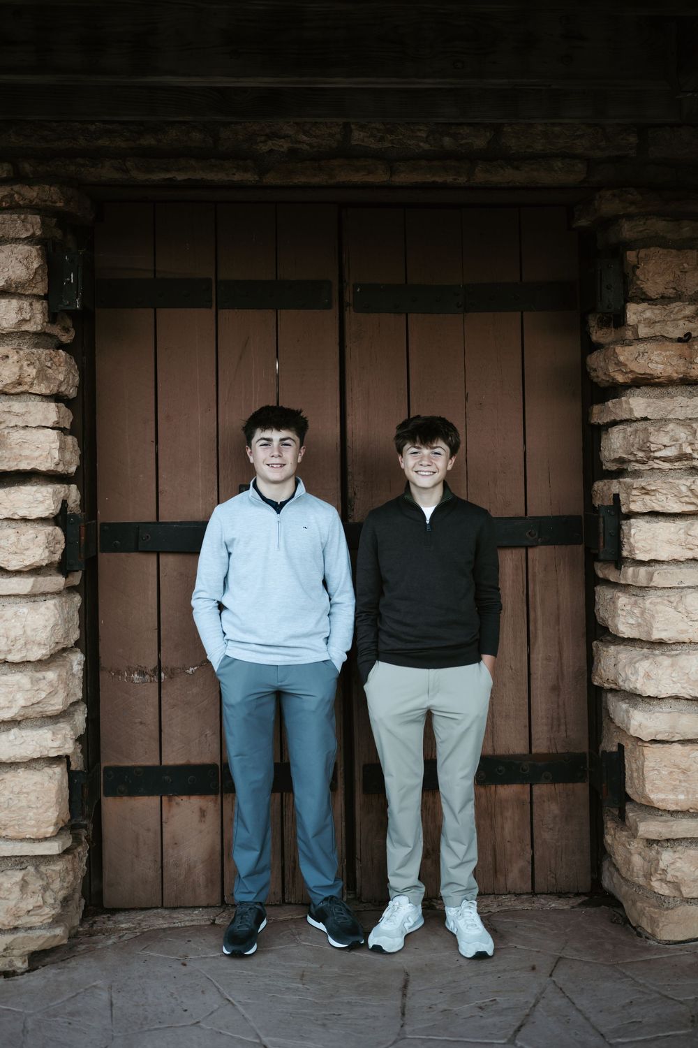 Two smiling teenage boys in casual jackets during family session in Oakbrook, IL