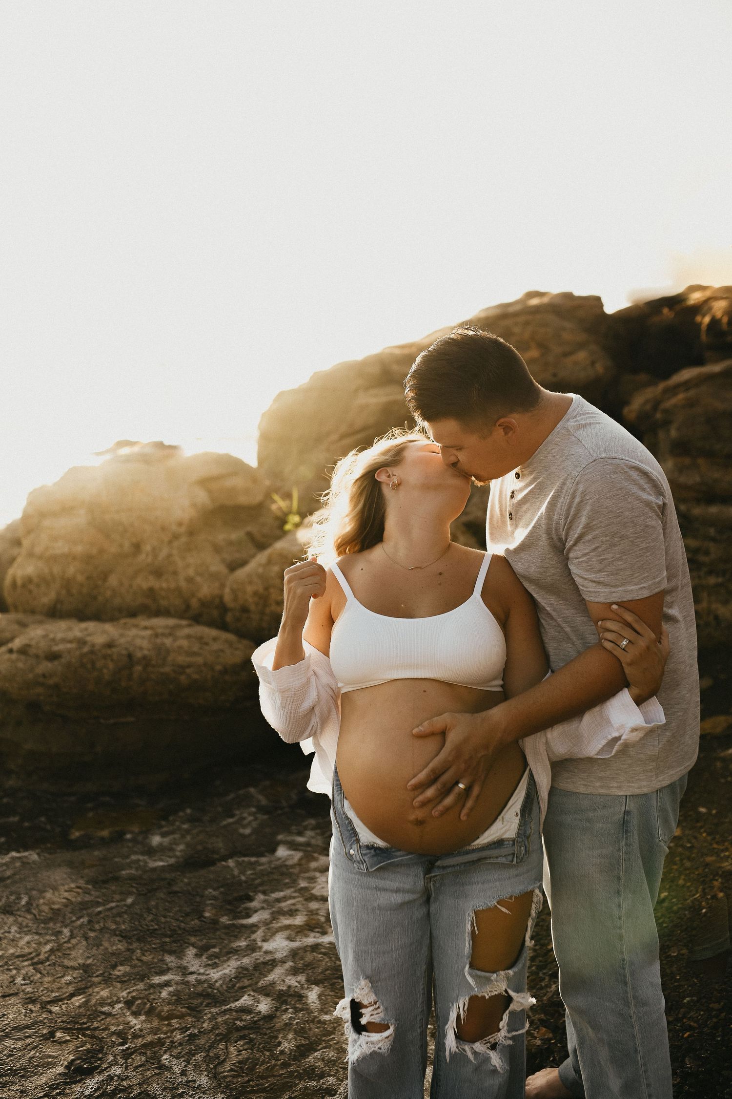 Romantic maternity portrait of expecting parents overlooking Lake Grapevine at sunset