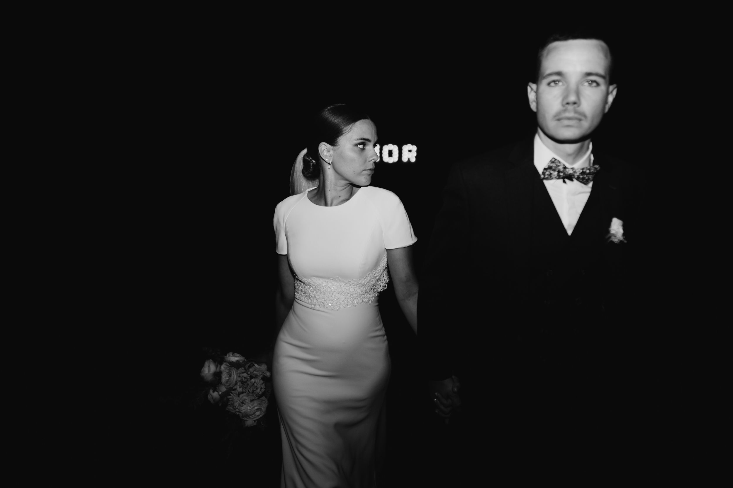 Elegant black and white photo of couple in formal wedding attire.
