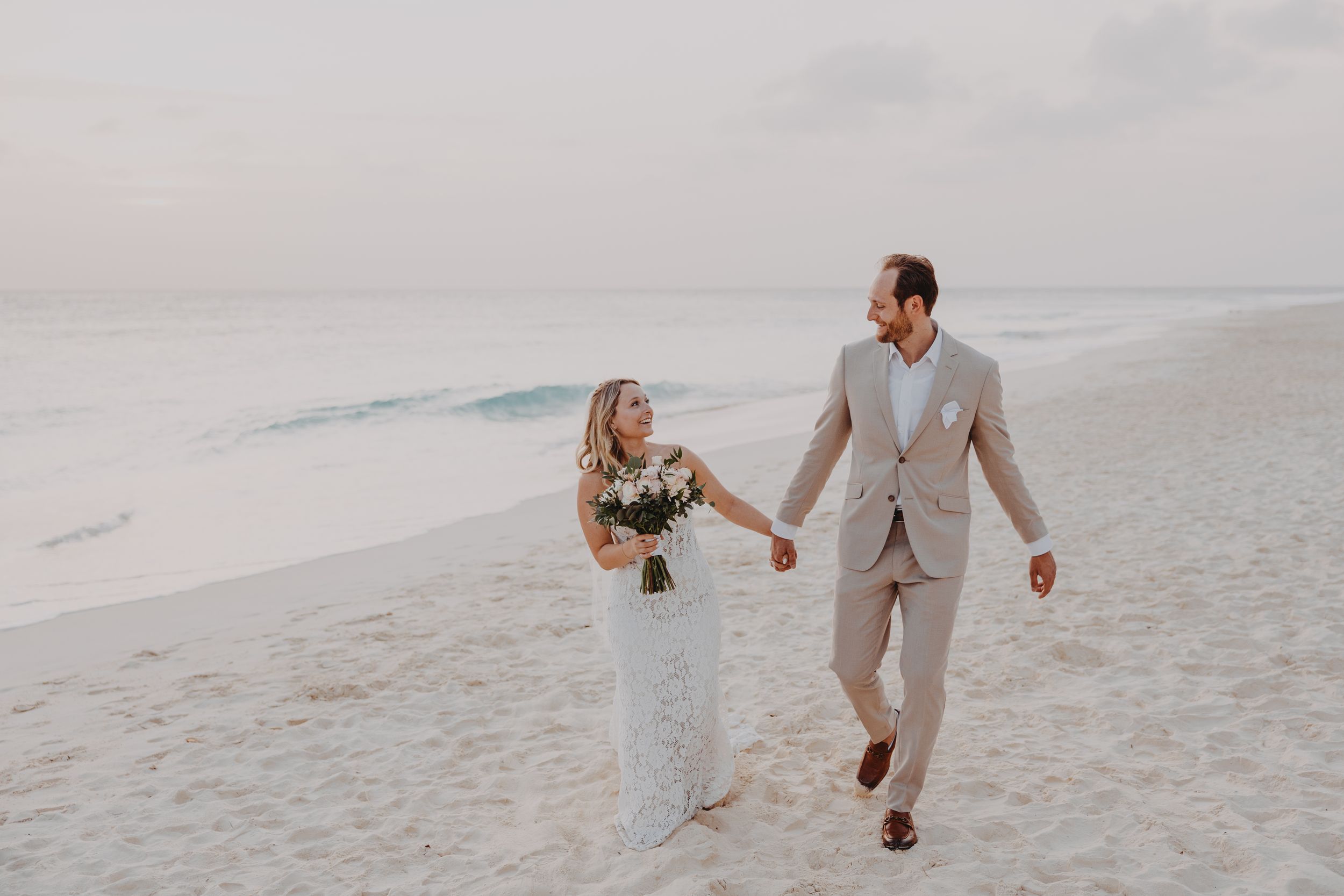 Aruba wedding couple walking along Eagle Beach at sunset