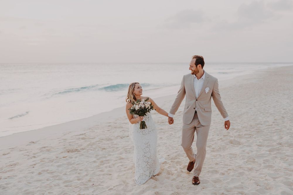 Aruba wedding couple walking along Eagle Beach at sunset