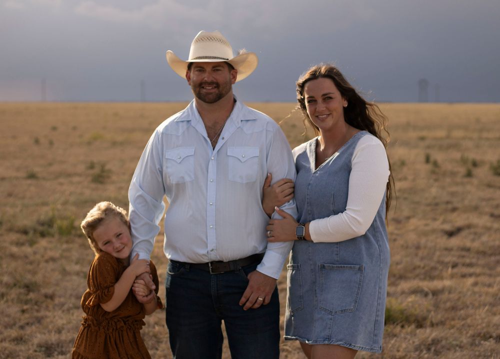 A family of three during a family photo session at an open field in Amarillo, Texas