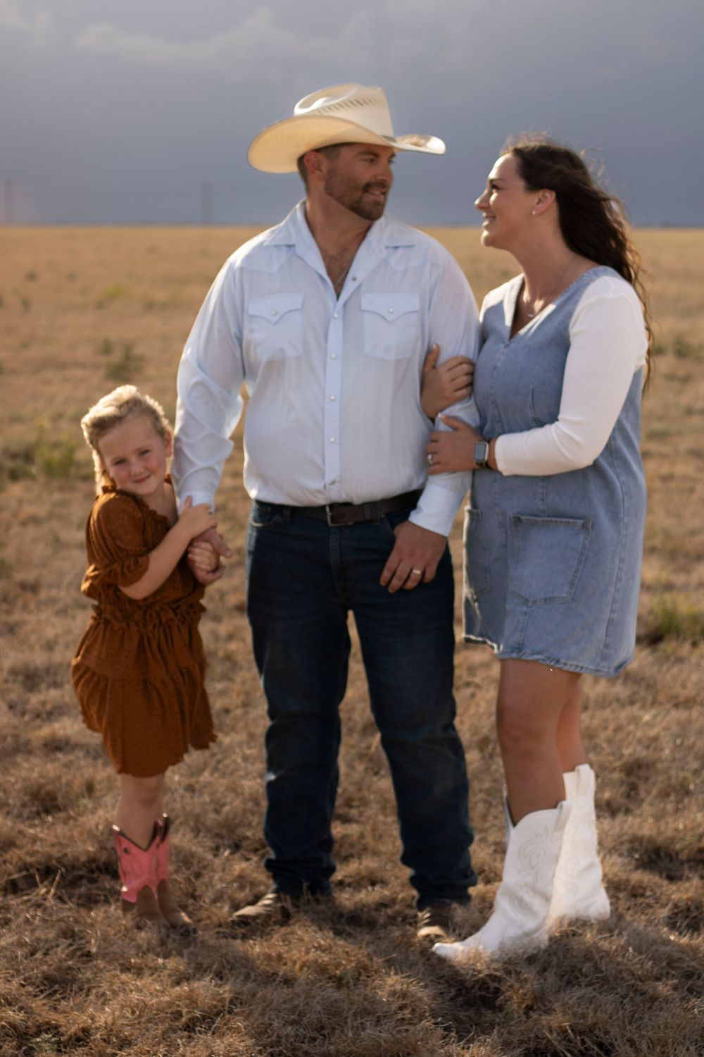 A family of three during a family photo session at an open field in Amarillo, Texas