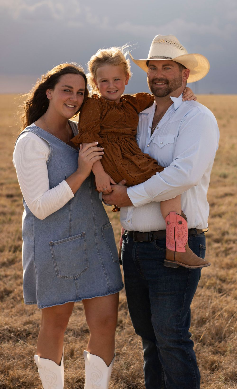 A family of three during a family photo session at an open field in Amarillo, Texas