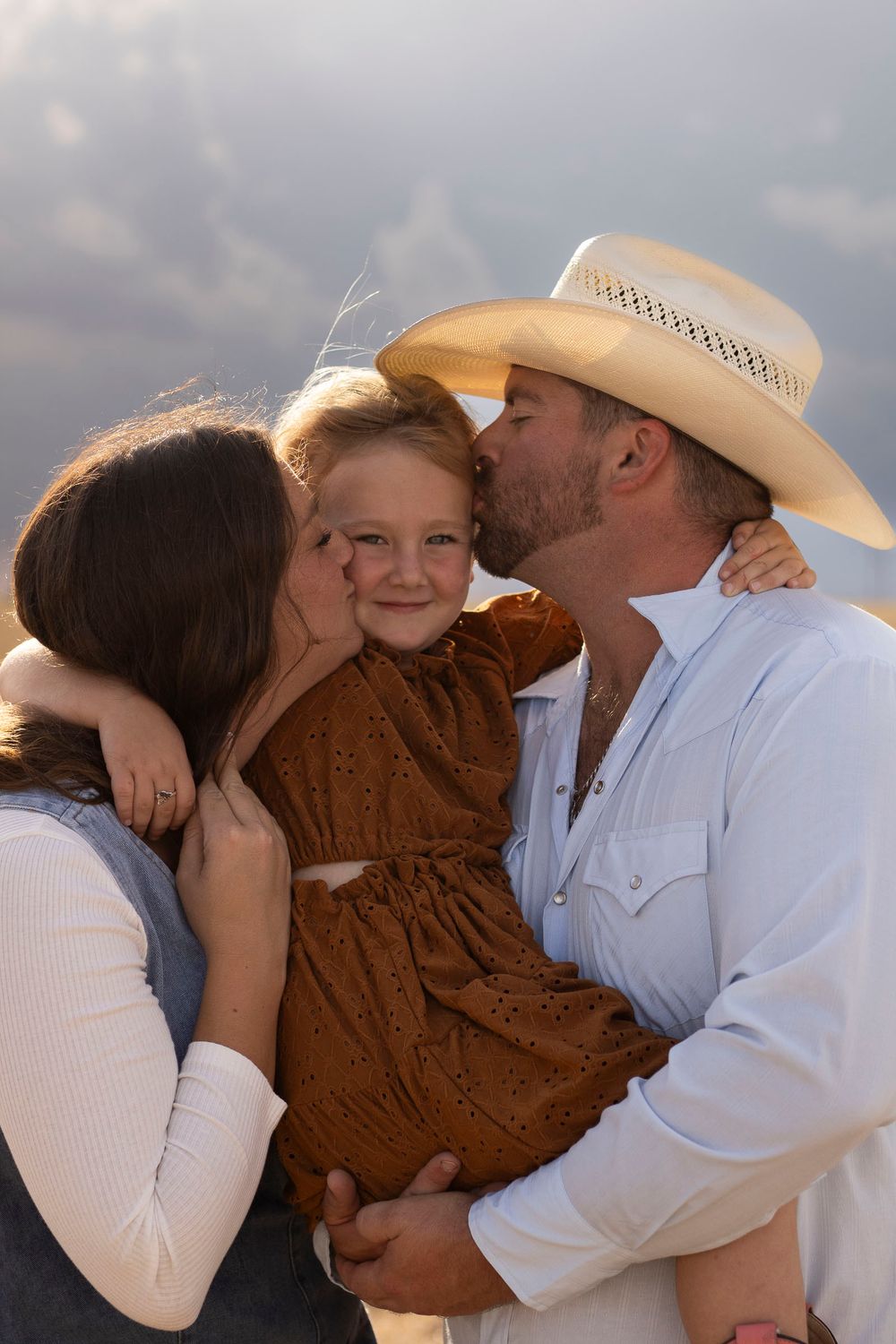 A family of three during a family photo session at an open field in Amarillo, Texas