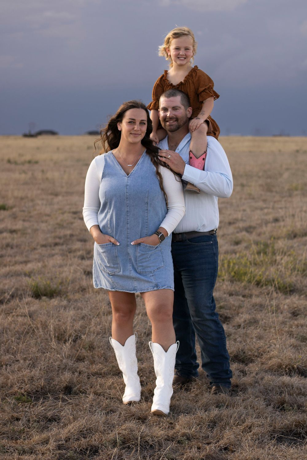A family of three during a family photo session at an open field in Amarillo, Texas