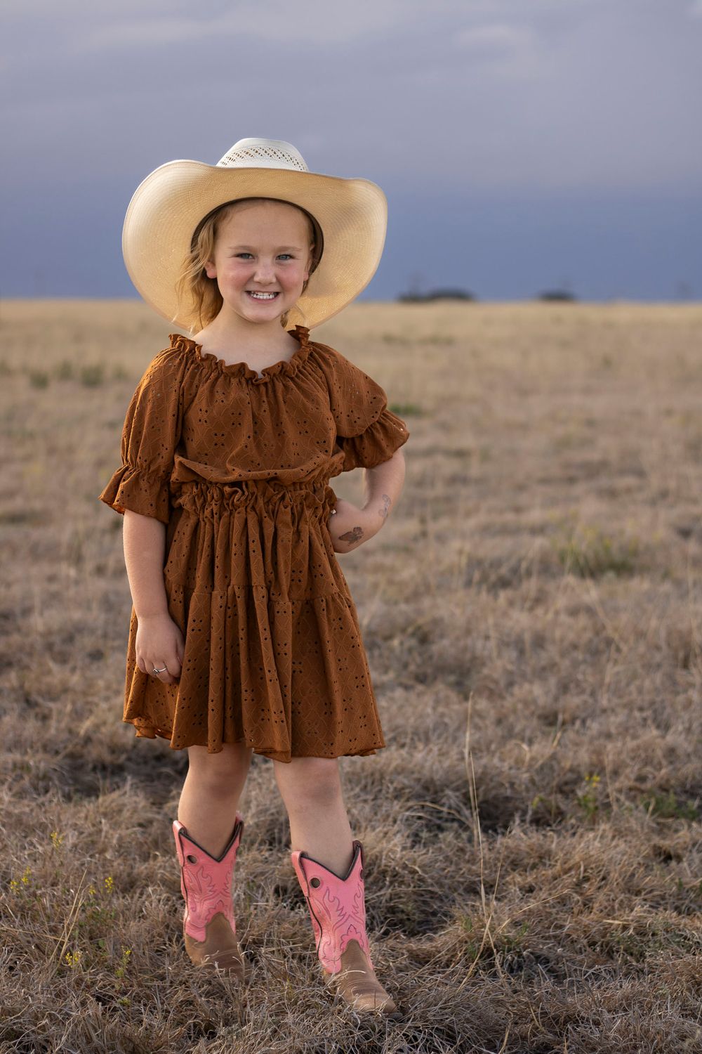A young girl during a family photo session at an open field in Amarillo, Texas