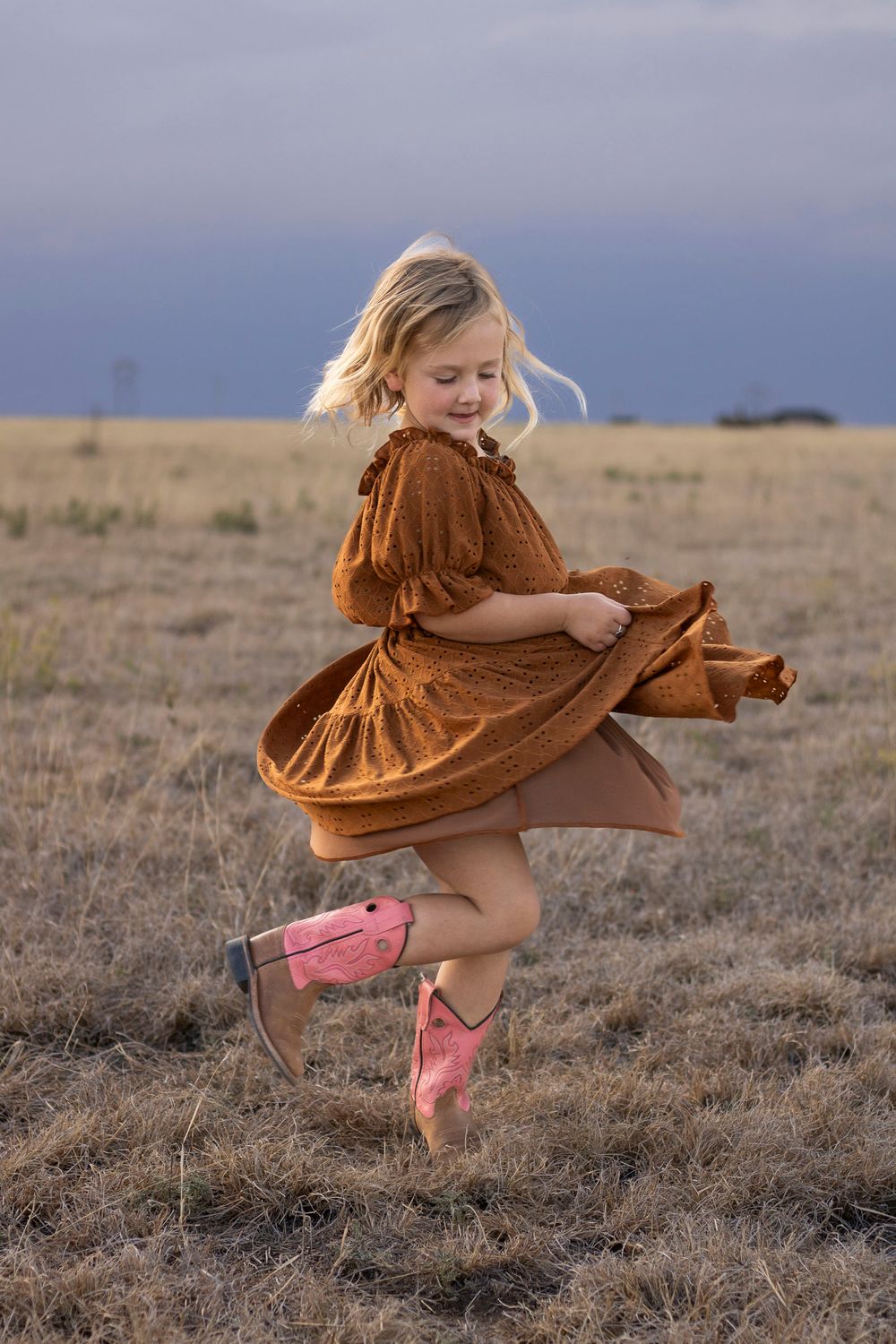 A young girl during a family photo session at an open field in Amarillo, Texas