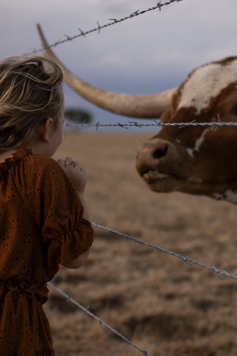 A young girl during a family photo session at an open field in Amarillo, Texas
