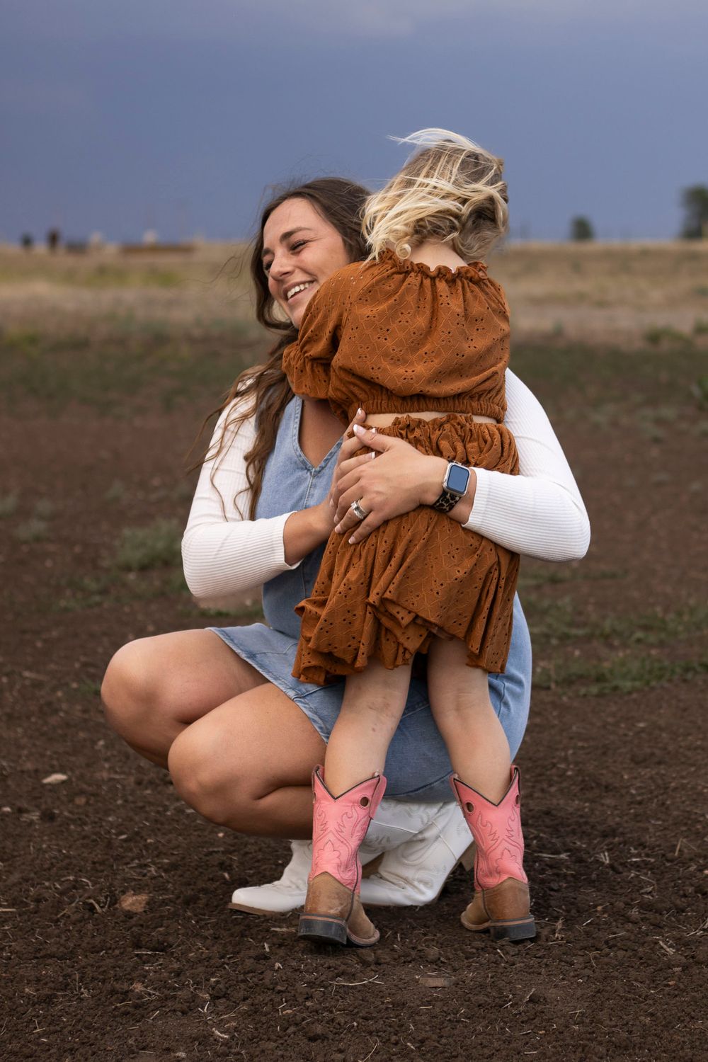 A mother and daughter during a family photo session at an open field in Amarillo, Texas