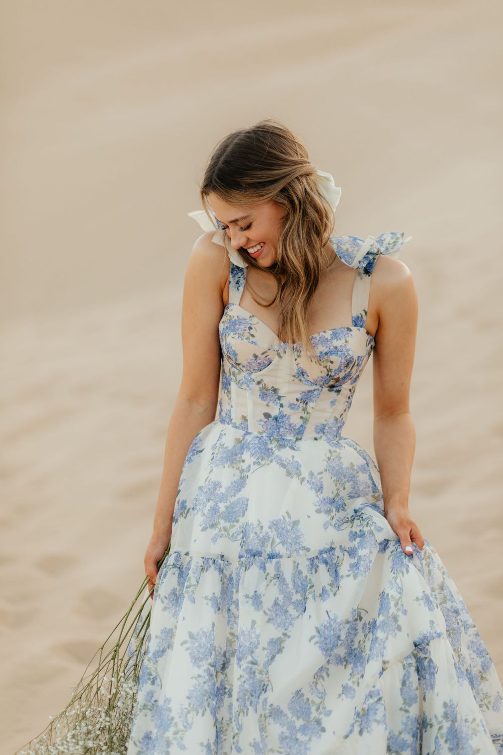 Girl Happy to Graduate in California/Arizona and is a graduate. In the sand dunes