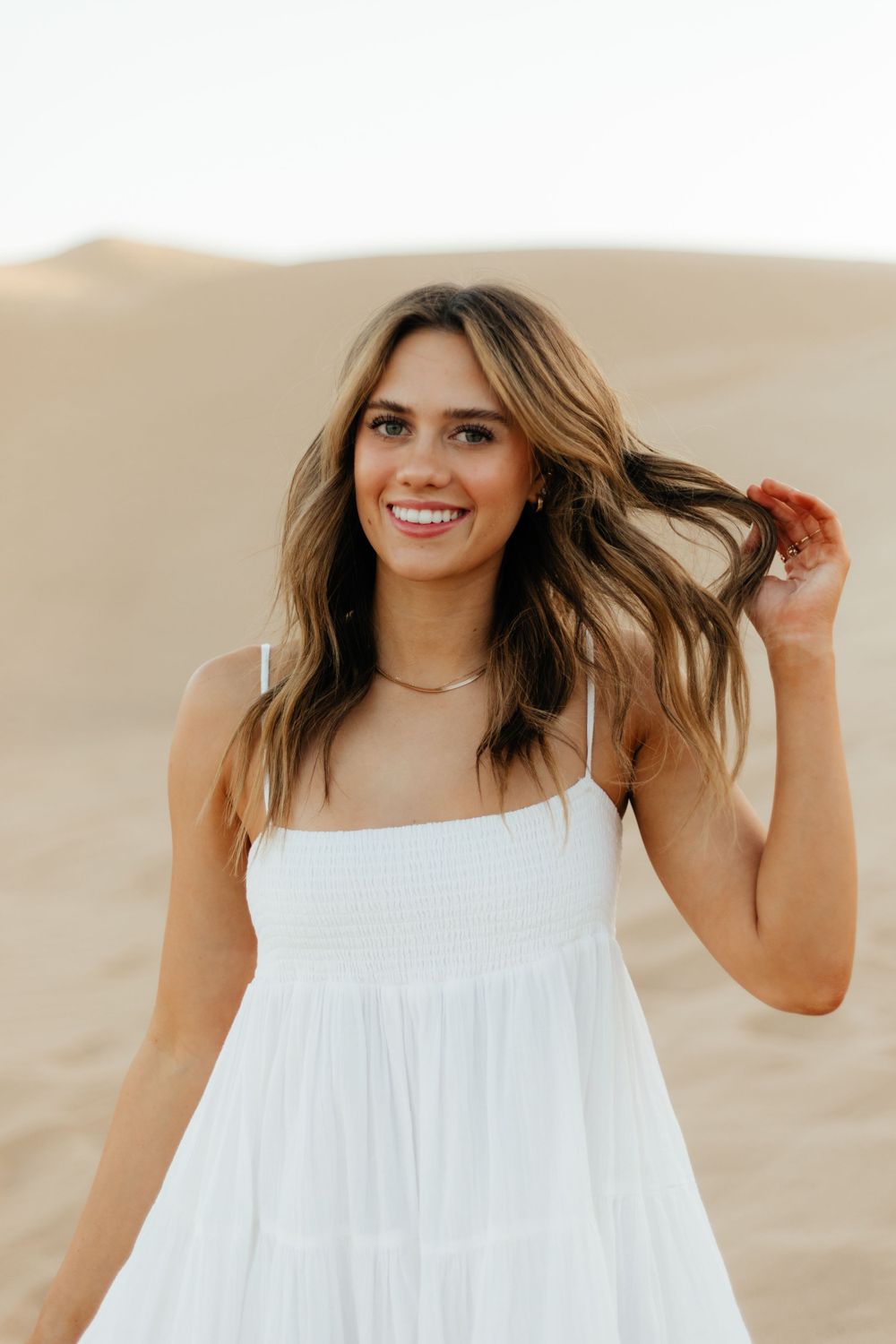 Girl Happy to Graduate in California/Arizona and is a graduate. In the sand dunes
