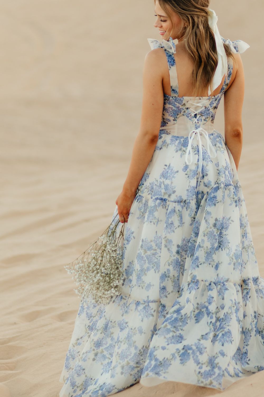 Girl Happy to Graduate in California/Arizona and is a graduate. In the sand dunes