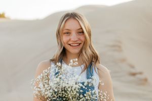 Girl Happy to Graduate in Utah and is a graduate. In the sand dunes