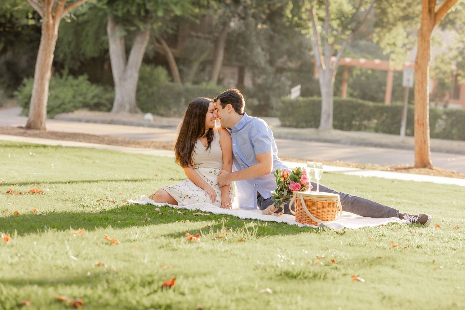 newly engaged couple celebrating their proposal at a park