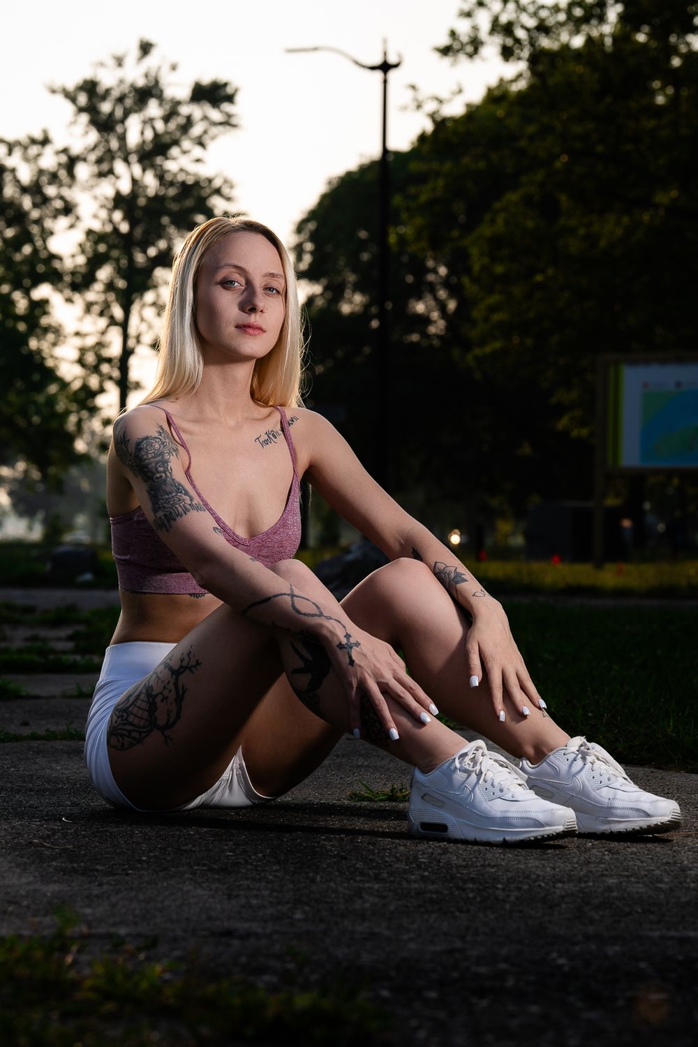 Urban fashion portraits with white sneakers and athleisure style clothing in late afternoon sunlight.