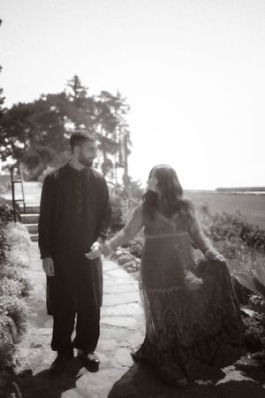 Black and white photo of couple on stone pathway with romantic vintage feel.